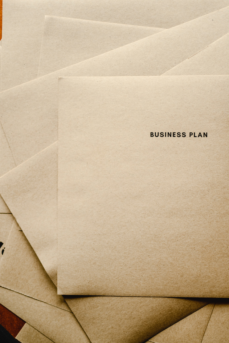 Close-Up Shot of a Business Plan Text on a Brown Paper