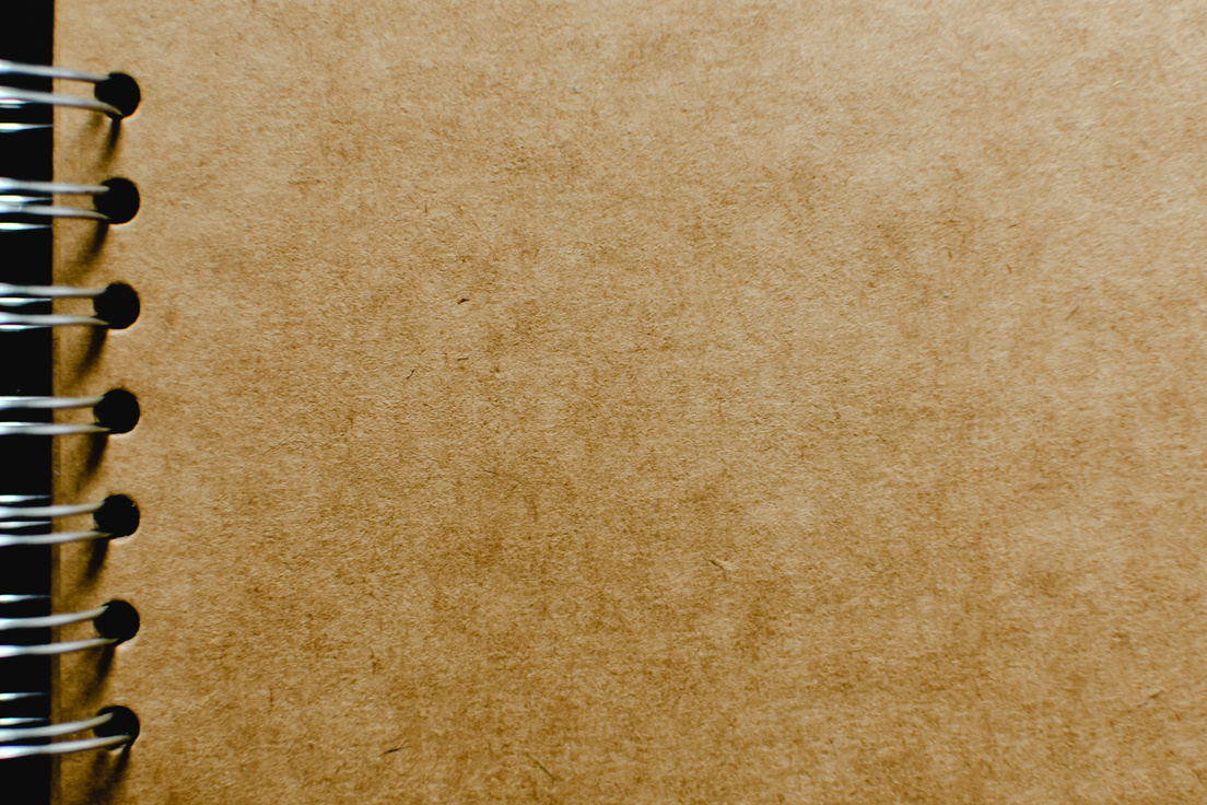 Extreme Close-up Photo of Kraft Notebook 