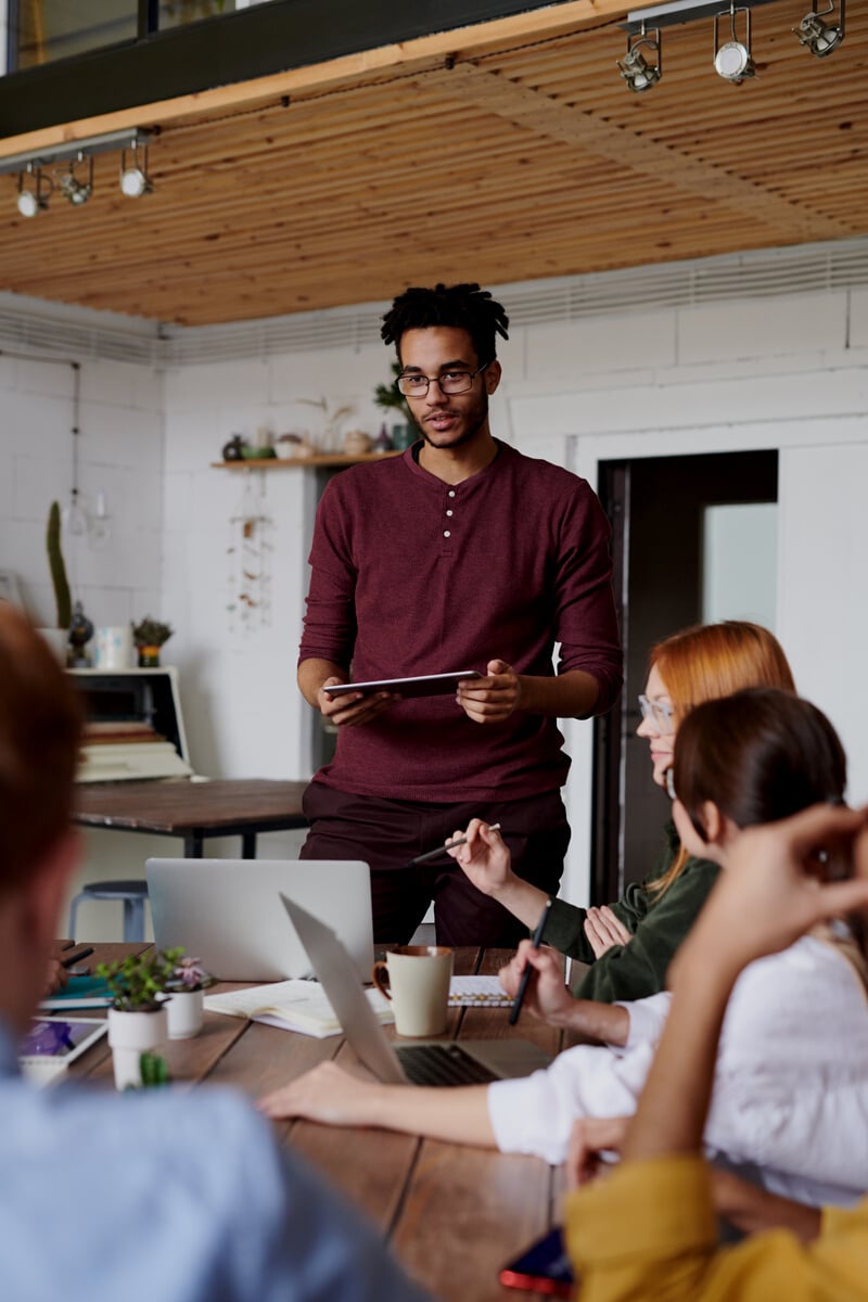 Photo Of Man Standing In Front Of People